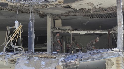Lebanese army soldiers inspect a destroyed house that was hit in an Israeli airstrike in Nabatieh town, south Lebanon, Friday, June 27, 2025. (AP Photo/Mohammed Zaatari)
