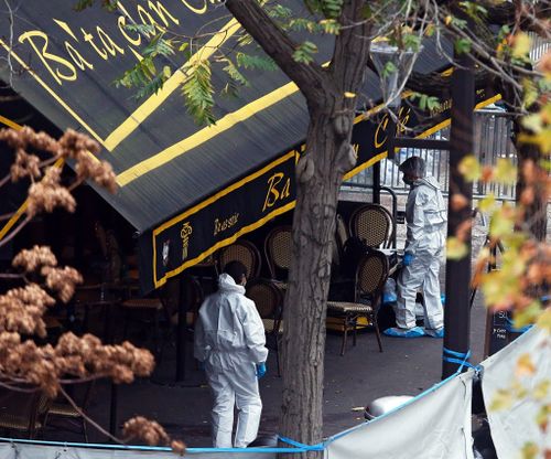 Forensic crews examine the entrance to the Bataclan. (AAP)