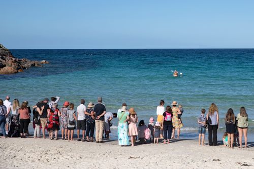 The bouquets and flowers mourners bought for Alby were paddled out to sea. (Caters)