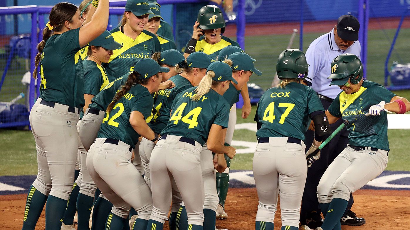 Jade Wall of Team Australia is greeted at home plate by her teammates after hitting a home run in the sixth inning against Team Mexico during softball opening round on day three of the Tokyo Olympic Games.