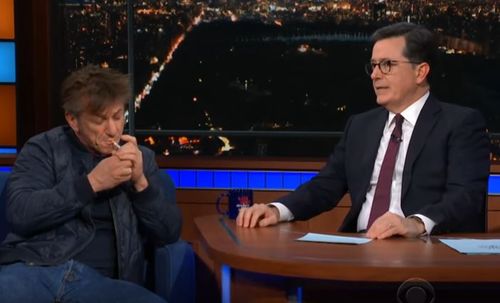 Sean Penn sparked up a cigarette during the bizarre interview with Stephen Colbert on his late show. (Supplied)