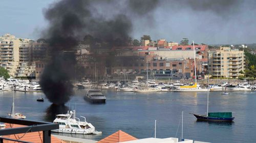 The boat caught fire near the Birkenhead Point shopping outlet.
