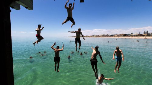Swimmers cool off at South Australia's Henley Beach. (AAP)