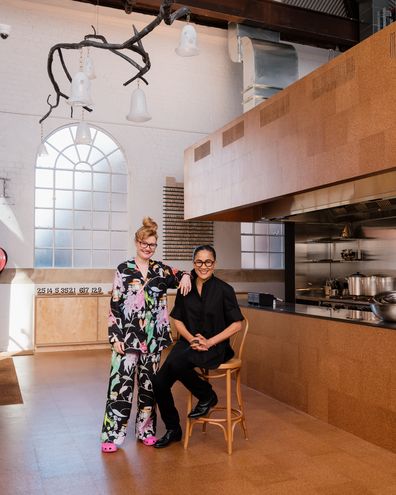 Kylie Kwong, with her wife Nell in her new restaurant - Lucky Kwong in South Eveleigh. Nell's artwork hangs above them in the in the main dining space. Photographed Friday 14th May 2021.