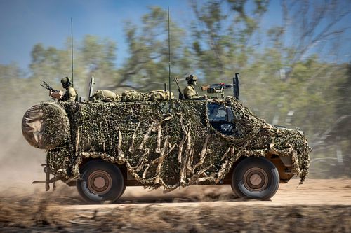 An Australian Army Bushmaster, like that sent to Ukraine, moves off road during a training mission