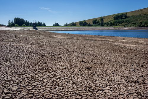 Dried and cracked mud is exposed as the water level at Beacons Reservoir recedes during the current heat wave, on August 12, 2022 in Merthyr Tydfil, Wales. 