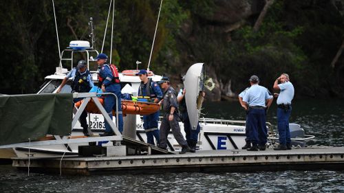 Divers recover parts of the sea plane and a body are recovered from the Hawkersbury River. (Image: AAP)