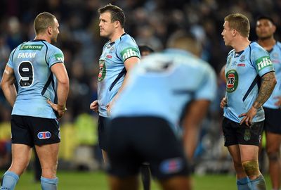 NSW players slump in dissapointment after the loss.