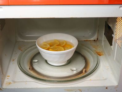 Bowl with water and slice lemons to clean microwave