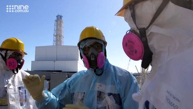 A Japanese official gives some last minute instructions to the 60 Minutes crew, before they venture inside reactor 3