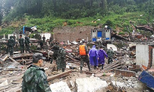 Chinese rescuers search for victims and survivors of a landslide caused by a barrier lake burst triggered by Typhoon Lekima, in Shanzao village, in east China's Zhejiang province. 