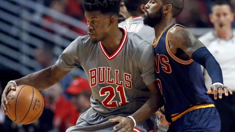 Bulls guard Jimmy Butler takes on Cleveland's Kyrie Irving. (AAP)