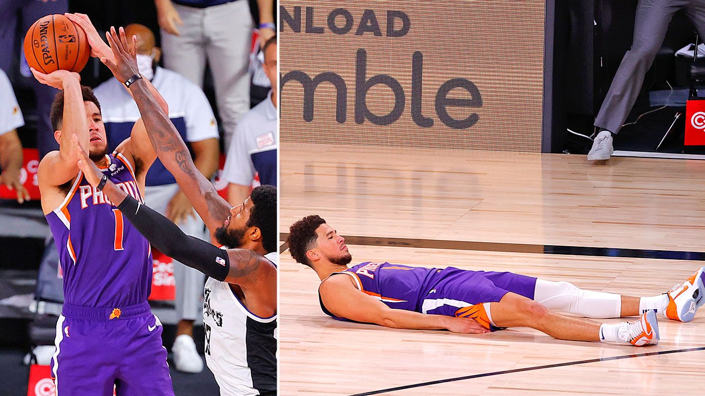 Devin Booker #1 of the Phoenix Suns shoots the game winning basket over Paul George #13 of the LA Clippers 