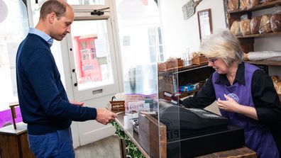  Prince William, Duke of Cambridge uses contactless payment to pay owner Teresa Brandon for his purchases during a visit to Smiths the Bakers, in the High Street on June 19, 2020 in King's Lynn, Norfolk.