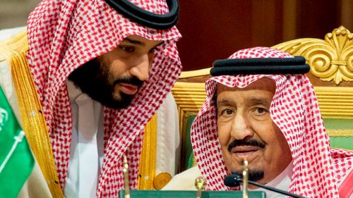 A file photograph shows Saudi Crown Prince Mohammed bin Salman speaking to his father, King Salman in Riyadh.