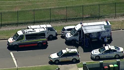 Police and ambulance vehicles block a street in Guildford during the police operation. (9NEWS)