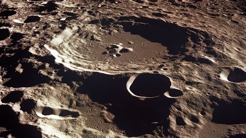 The moon is covered in craters like Daedalus, as seen by the Apollo 11 crew on the moon's far side.