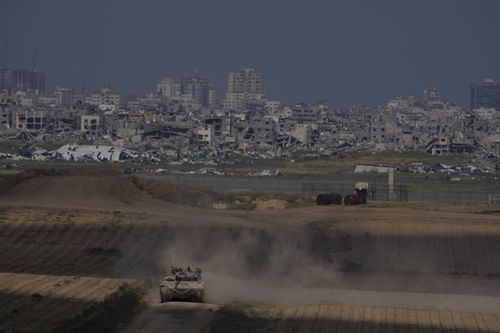 Israeli soldiers move on the top of a tank near the Israeli-Gaza border, as seen from southern Israel, Tuesday, April 9, 2024.