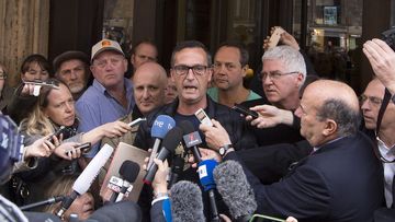 David Ridsdale, center, flanked by other members of the Australian group of relatives and victims of priestly sex abuses, talks to reporters outside of the Quirinale hotel after their meeting with Australian cardinal George Pell, in Rome. (AAP)