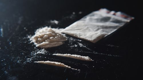 Hard drugs on black table. Close up