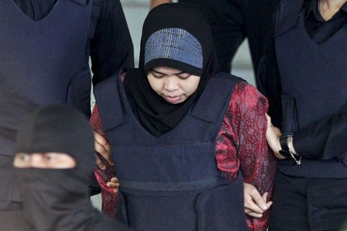 Indonesian Siti Aisyah is escorted by police as she leaves after a court hearing at Shah Alam High Court in Shah Alam, Malaysia