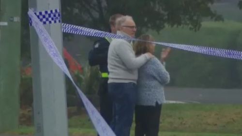 Mr Goland's parents at the scene of the fatal crash this morning. (9NEWS)