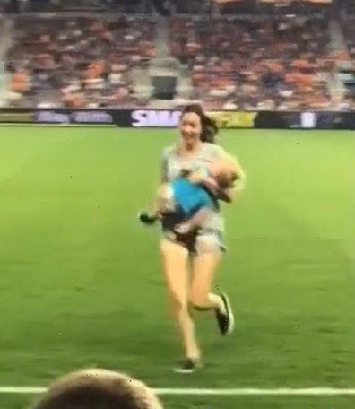 Mum runs off the grounds with her toddler firmly in hand.