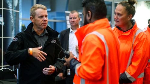 New Zealand Prime Minister Chris Hipkins, left, visits the Emergency Civil Defence Centre