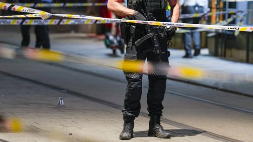 Police gather at the site of a mass shooting in Oslo, early Saturday, June 25, 2022. Norwegian police say a few people have been killed and more than a dozen injured in a mass shooting. (Javad Parsa/NTB via AP)