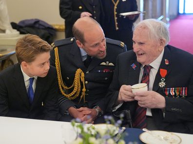 Prince George of Wales and Prince William, Prince of Wales speak with Second World War veterans at a tea party in Buckingham Palace on May 5, 2025 in London, England. 