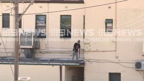 He was brandishing a machete but surrendered to police this morning (9NEWS)