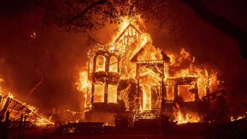 Flames from the Glass Fire consume the Black Rock Inn at St Helena, California.