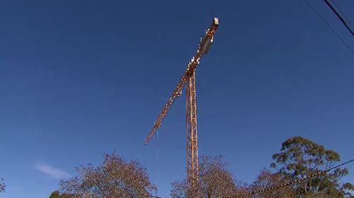 Paramedics who arrived on the scene had to use a crane and workers' box to access the man and lift him to safety. Picture: 9NEWS.