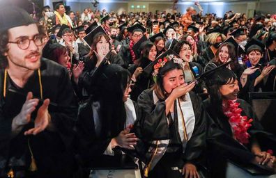 Miranda Kerr and husband Evan Spiegel surprise graduating college students by paying off all $14 million of their student loans.