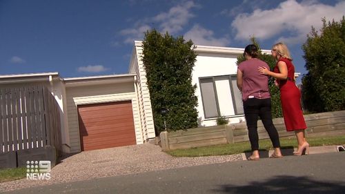 People standing in front of property