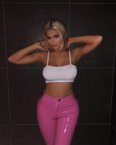 Kylie posed in hot pink latex pants for a behind-the-scenes photo of&nbsp;her new makeup collection shoot in September, 2018<br />
<br />
<br />
