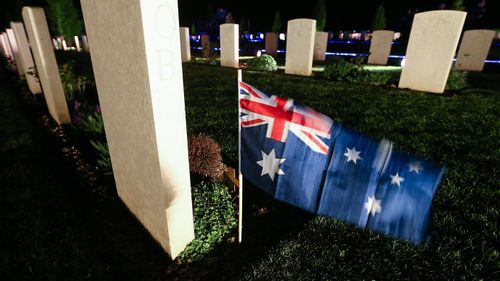 An Australian flag by the tomb of a soldier at the Australian military cemetery.