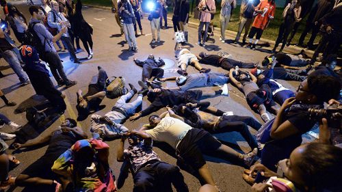 Protesters block the road in front of Bank of America Stadium in Charlotte on September 22, 2016. (AAP)