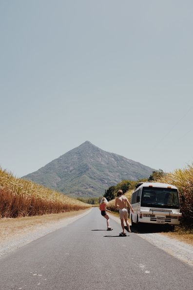 Van life influencers skateboarding on a deserted road