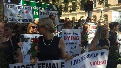 Anti-violence campaigners gather near Queensland's parliament in Brisbane on Thursday, April 7, 2016 in the name of two women allegedly killed in domestic violence incidents days apart. (AAP)