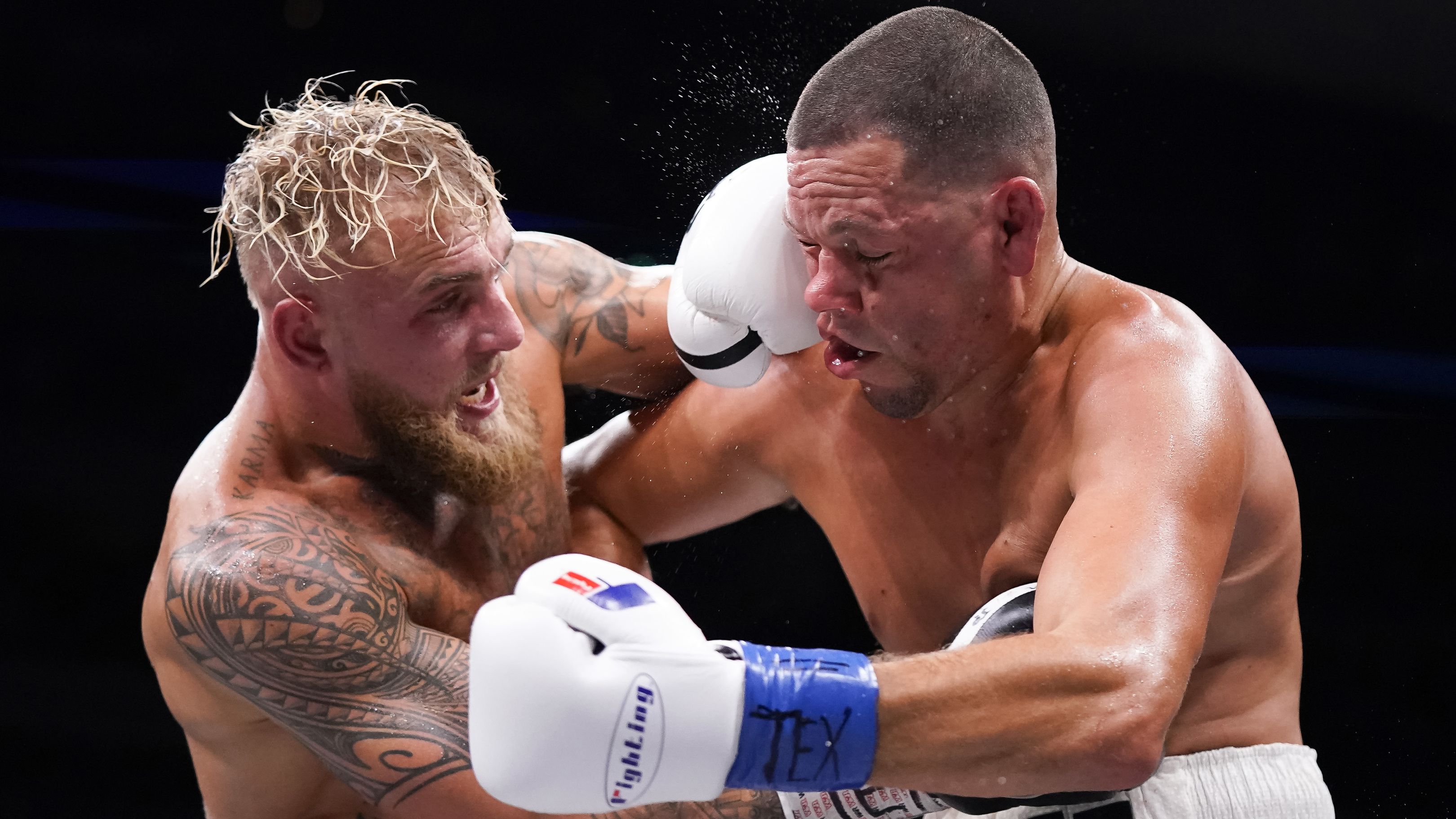 DALLAS, TEXAS - AUGUST 05: Jake Paul, left, and Nate Diaz, right, trade punches during the third round of their fight at the American Airlines Center on August 05, 2023 in Dallas, Texas. (Photo by Sam Hodde/Getty Images)