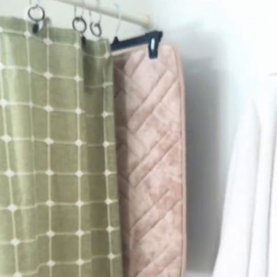 Lauren's bath mat drying hack using a coat hanger