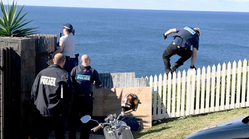 Police are seen at the home of Kings Cross club owner John Ibrahim during a police operation in Sydney, Tuesday, August 8, 2017. (AAP)