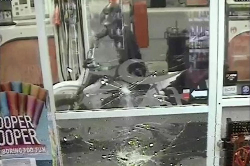 Police allege the two suspects smashed the service station window before attacking the worker with a hammer.