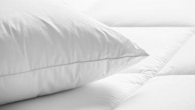 Closeup of white pillow on the bed in the bedroom