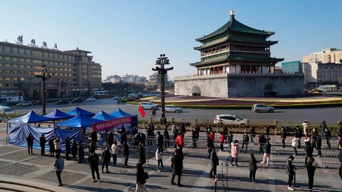 Residents line up for tests at a COVID-19 testing site in Xi'an in northwestern China's Shaanxi Province.