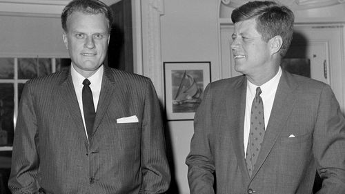 Evangelist Billy Graham talks with President John F. Kennedy at the the White House. (AAP)