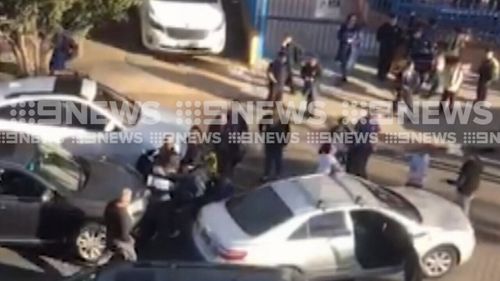 Several mums were seen pushing and shoving in the school car park. (9NEWS)
