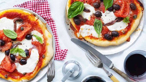 Mozzarella, tomato, olive and caper pizza. Image: Gourmet Traveller WINE