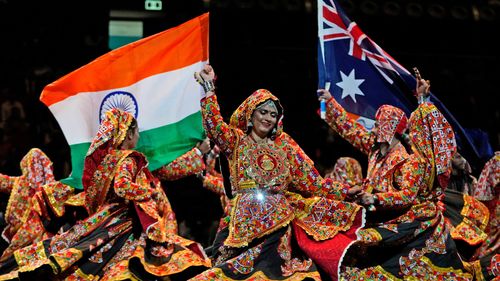 Dancers wave Australian and Indian national flag as they perform ahead of Indian Prime Minister Narendra Modi's arrival